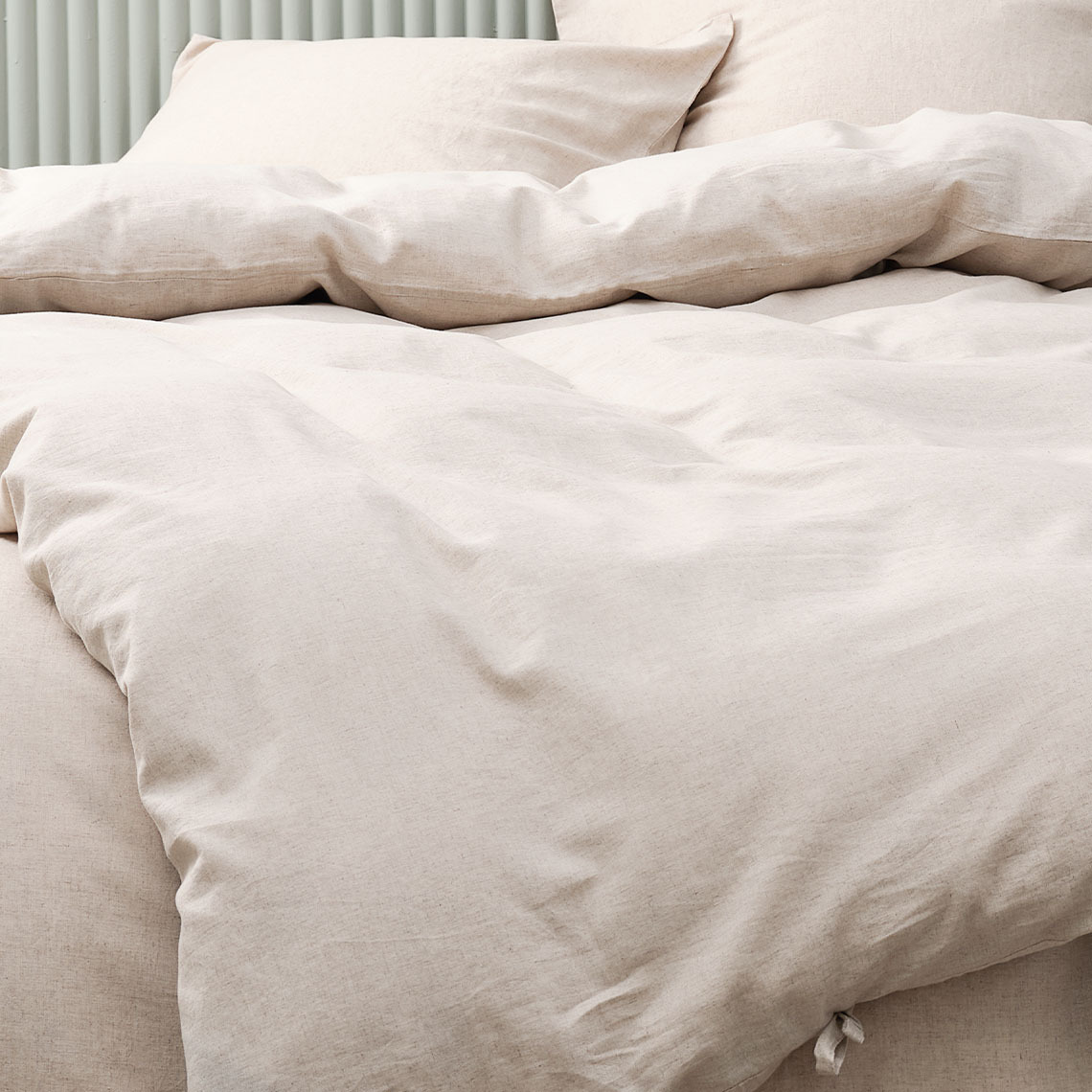Bedding made from linen is great for staying cooler throughout the night Beige bedding made from a blend of cotton and linen