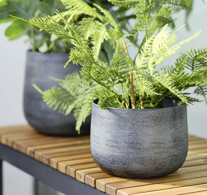 RUSTAND garden planter Garden planter with green plant placed on wooden bench