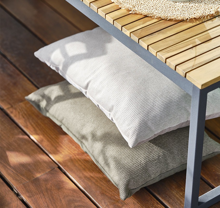 Balcony with wood floor and two cushions in green and beige