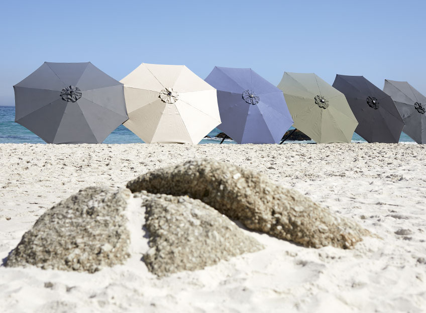 Parasols in different colours on a beach  