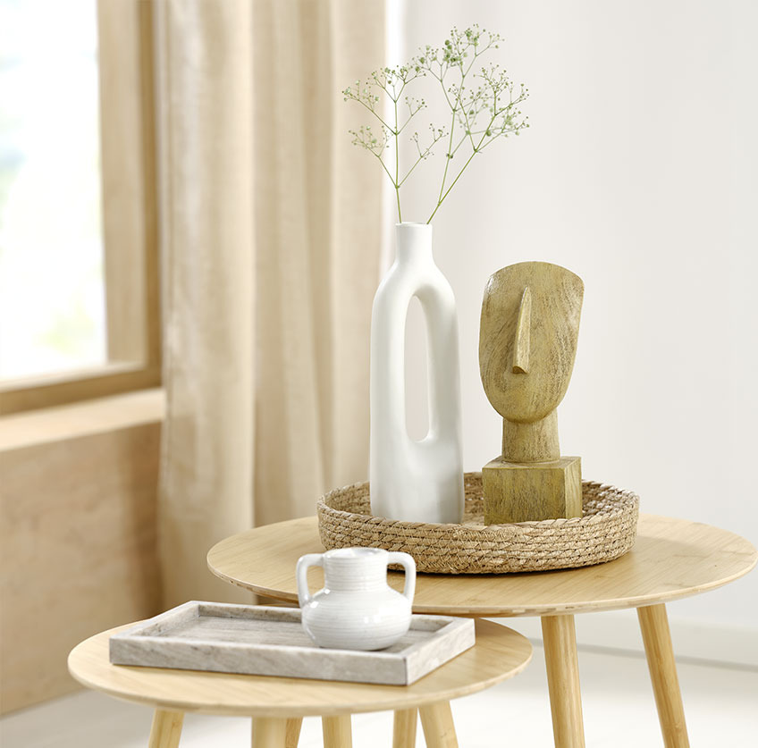 Vassoio in marmo con portacandele bianco e vassoio in seagrass con vaso bianco e scultura